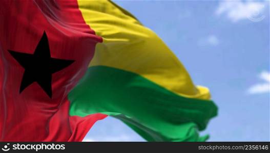 Detail of the national flag of Guinea-Bissau waving in the wind on a clear day. Guinea-Bissau is a country in West Africa. Selective focus.