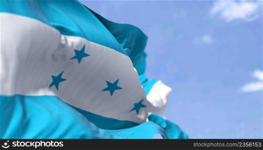 Detail of the national flag of Honduras waving in the wind on a clear day. Honduras is a country in Central America. Selective focus.