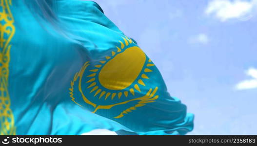 Detail of the national flag of Kazakhstan waving in the wind on a clear day. Kazakhstan is a transcontinental country located mainly in Central Asia, and partly in Eastern Europe. Selective focus.