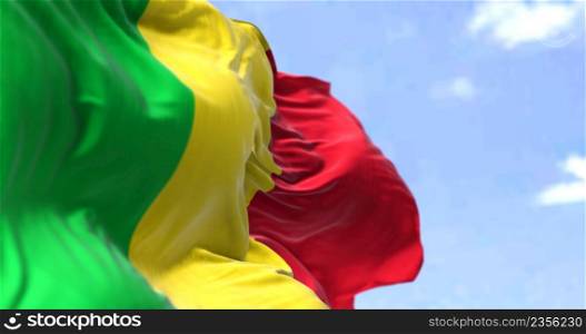 Detail of the national flag of Mali waving in the wind on a clear day. Mali is a landlocked country in West Africa. Selective focus.