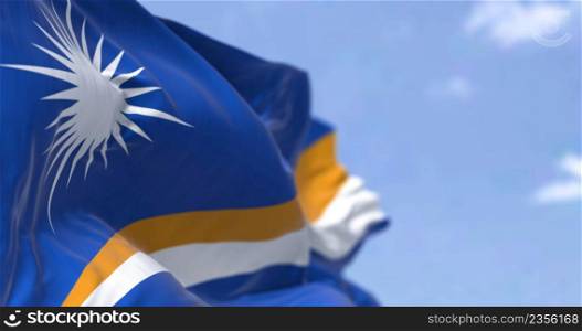 Detail of the national flag of Marshall Islands waving in the wind on a clear day. Marshall Islands is an independent island country near the Equator in the Pacific Ocean. Selective focus.