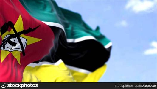 Detail of the national flag of Mozambique waving in the wind on a clear day. Mozambique is a country located in Southeastern Africa. Selective focus.