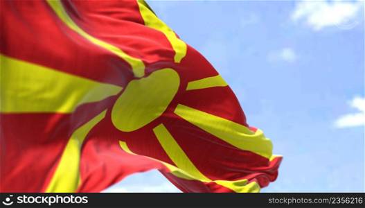 Detail of the national flag of North Macedonia waving in the wind on a clear day. North Macedonia is a country in Southeast Europe. Selective focus.