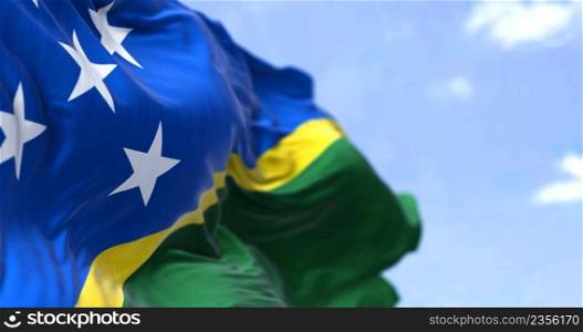 Detail of the national flag of Solomon Islands waving in the wind on a clear day. Solomon Islands is a sovereign country in Oceania. Selective focus.