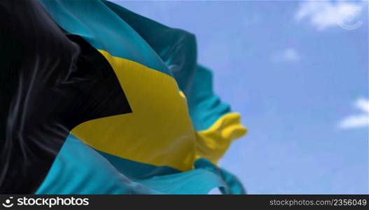 Detail of the national flag of the Bahamas waving in the wind on a clear day. Bahamas is a sovereign country within the Lucayan Archipelago of the West Indies in the Atlantic. Selective focus.