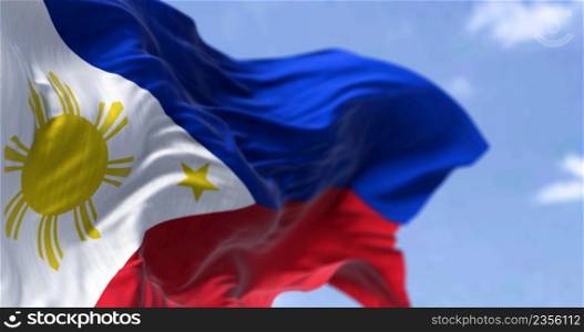 Detail of the national flag of the Philippines waving in the wind on a clear day. The Philippines is an archipelagic country in Southeast Asia. Selective focus.