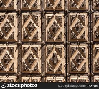 Detail of the solid wood carved door with iron patterns of Convento de San Estaban in Salamanca Spain. Detail of the solid door of the Convent of San Estaban in the old Salamanca in Spain