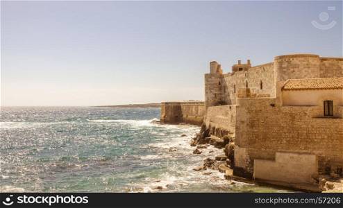 Detail of the wall on the sea of medieval Maniace's Castle in Siracusa
