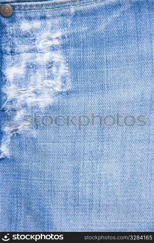 detail of torn blue denim, front view