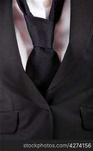 Detail of woman&acute;s suit and tie