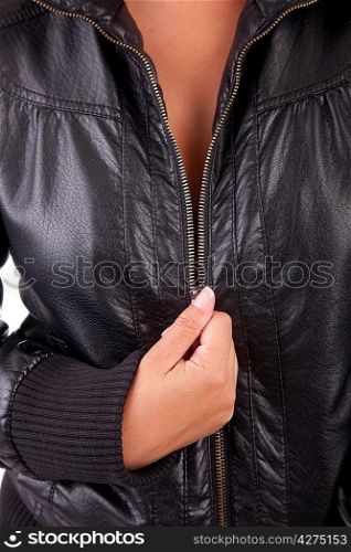 Detail of woman unzipping black coat