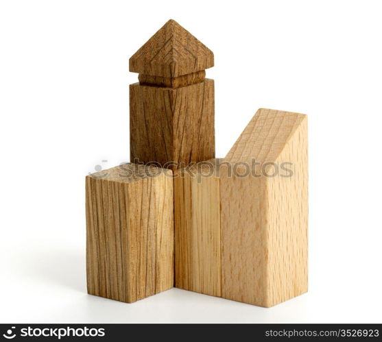 Detail of wooden puzzle in the form of buildings on white background. Macro.