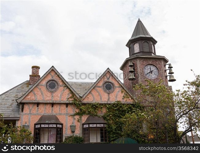 Detail on old building with belltower and clock in danish town of Solvang in California