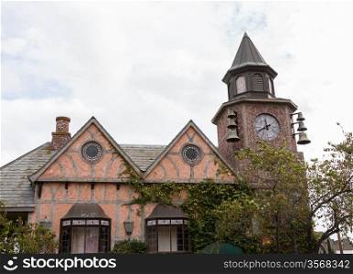 Detail on old building with belltower and clock in danish town of Solvang in California