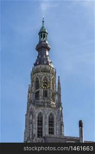 detail tower of the old great church of breda with its colorful clock. holland netherlands