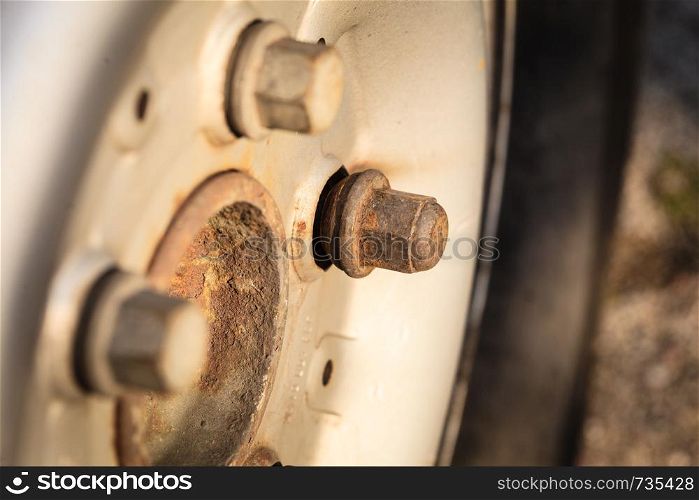 Detailed close up of rim wheel screw. Car parts, auto mechanics concept.. Detailed closeup of rim wheel screw