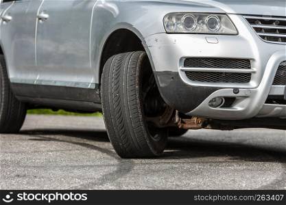Detailed close up of twisted car wheel, automobile vehicle machine details concept.. Detailed closeup of twisted car wheel