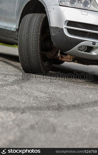 Detailed close up of twisted car wheel, automobile vehicle machine details concept.. Detailed closeup of twisted car wheel