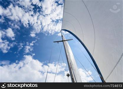 Detailed closeup of sail fabric on sailboat, outdoor shot. Marine objects concept.. Detailed closeup of sail on sailboat