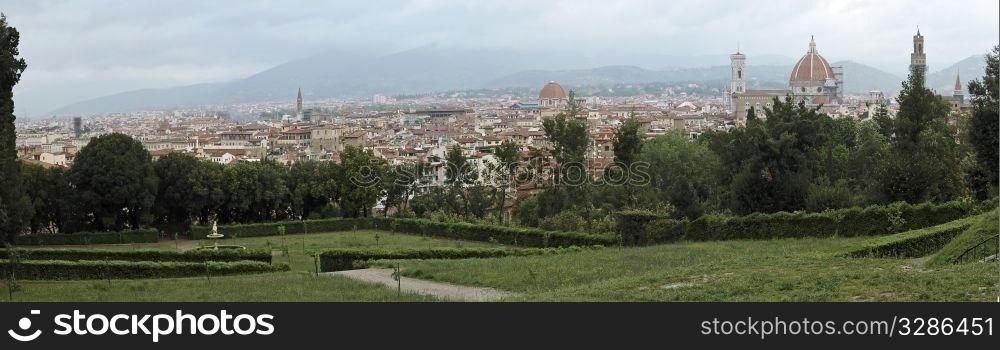 Detailed panoramic view of Florence, Italy. From green garden. Cloudy cold spring.