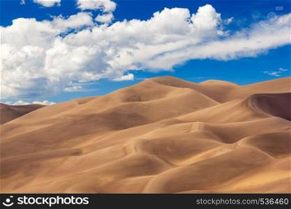 Detailed shot of the shadows on the dunes at Great Sand Dunes National Park in Colorado on a bright sunny but cloudy day. Panorama of Great Sand Dunes NP