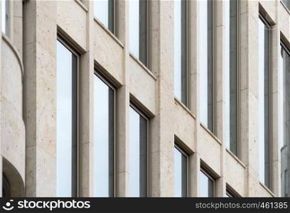 Detailed view of a building with high straight windows, strict geometry, architecture