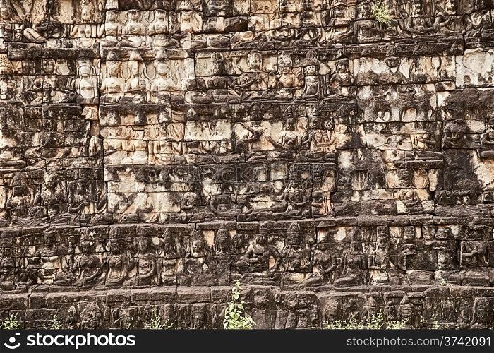 Detailed view showing several levels of one of the walls underneath the ruins of the Leper King Terrace in the Angkor Thom complex in Cambodia.&#xA;