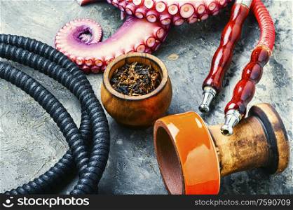 Details of hookah and smoking tobacco.Smoking hookah for relaxation.Octopus hookah tobacco.. Asian hookah tobacco