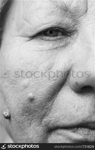 Details of senior woman half face. Elderly pensioner female, cheek close up.. Elderly pensioner female half face portrait closeup