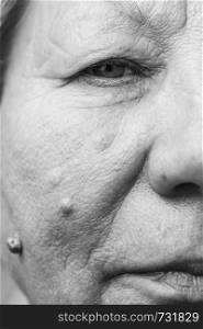 Details of senior woman half face. Elderly pensioner female, cheek close up.. Elderly pensioner female half face portrait closeup