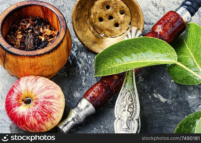 Details of the eastern hookah.Hookah with apple flavor.Smoking apple tobacco. Smoking hookah with apple