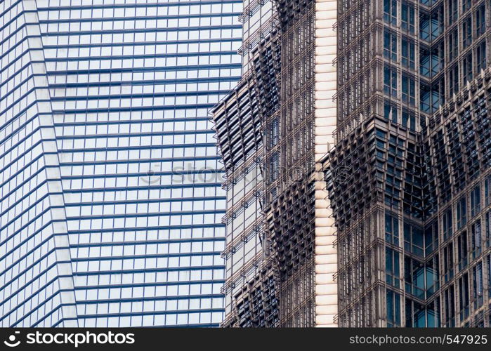 details of the facade of a modern skyscraper made of glass and steel closeup. Shanghai World Financial Center.. Shanghai, China - January 15, 2018: details of the facade of a modern skyscraper made of glass and steel closeup. Shanghai World Financial Center