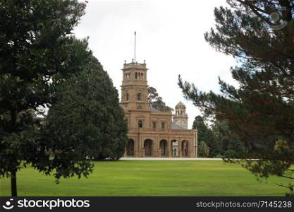 details of the old world architecture on the grand mansion viewed through the gardens at Werribee mansion, an old large Australian property near Melbourne Victoria, Australia