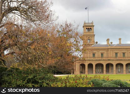 details of the old world architecture on the grand mansion viewed through the gardens at Werribee mansion, an old large Australian property near Melbourne Victoria, Australia