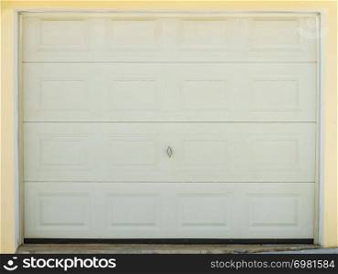 Details of the white garage door. Household car space exterior design concept.. White garage door outdoor design.