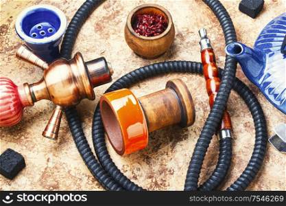 Details of tobacco hookah and teapot with tea.Eastern smoking shisha. Turkish smoking hookah and tea.