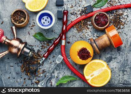 Details of tobacco hookah and tobacco with orange aroma.Fruit shisha. Oriental hookah with orange flavor.