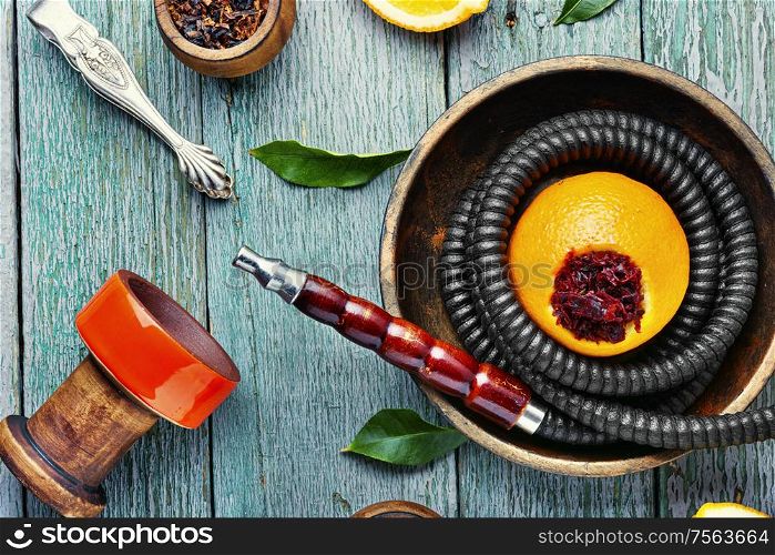 Details of tobacco hookah and tobacco with orange aroma.Fruit shisha. Oriental hookah with orange flavor.