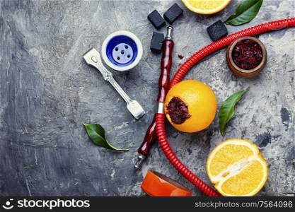 Details of tobacco hookah and tobacco with orange aroma.Fruit shisha. Hookah with orange tobacco.