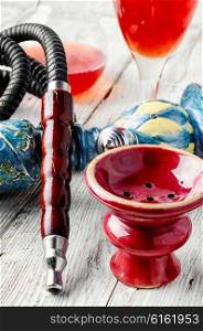 Details smoking Arab hookah and a glass of young wine pink. Hookah and wine