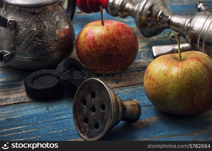 details smoking hookah on background of apples