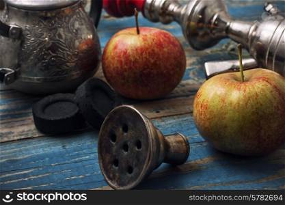 details smoking hookah on background of apples