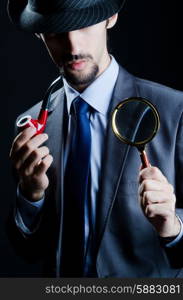 Detective with magnifying glass and pipe