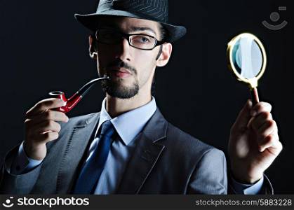 Detective with magnifying glass and pipe
