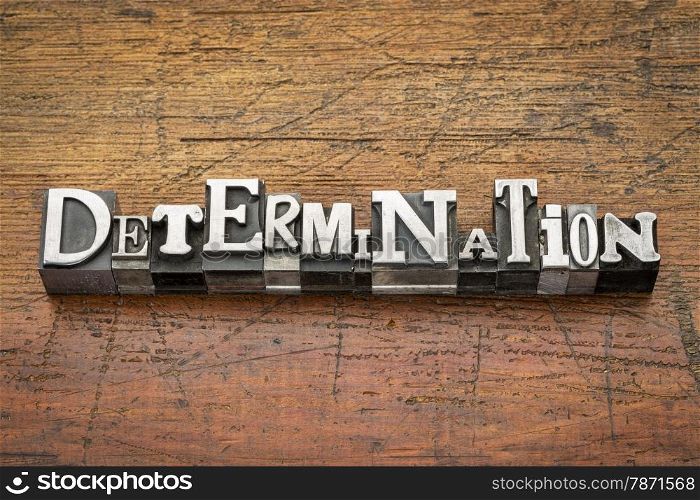 determination word in mixed vintage metal type printing blocks over grunge wood