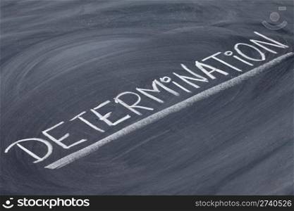 determination word in white chalk handwriting on blackboard