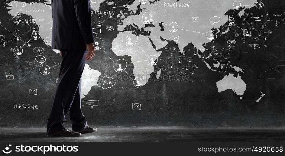 Determined and goal oriented. Rear view of businessman in elegant suit looking at business ideas on wall