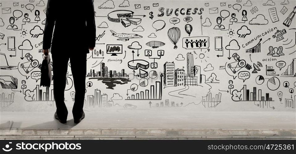 Determined and goal oriented. Rear view of businessman with suitcase looking at business ideas