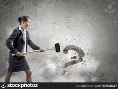 Determined businesswoman. Young pretty businesswoman crashing stone question symbol