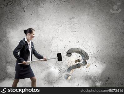 Determined businesswoman. Young pretty businesswoman crashing stone question symbol